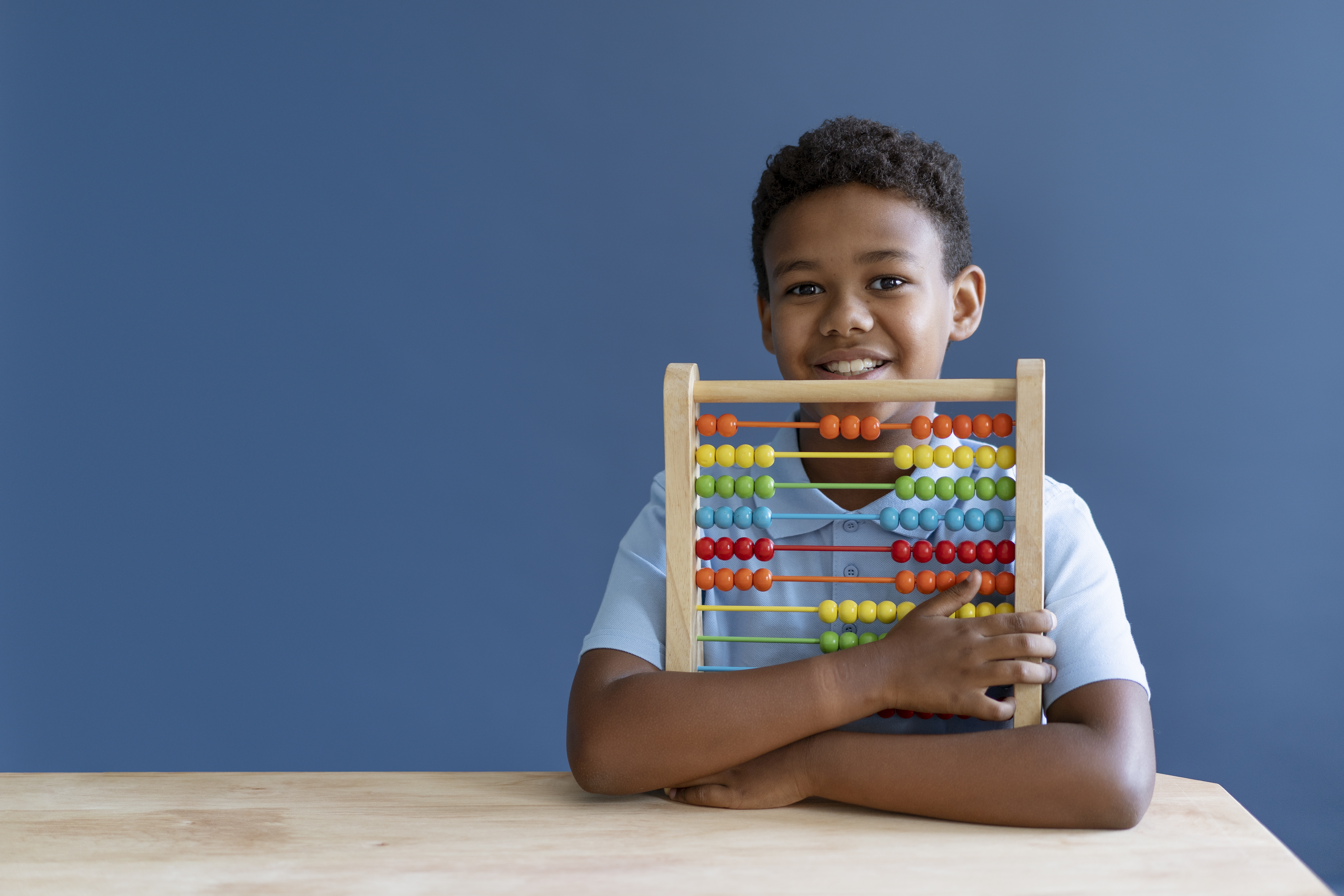 Schoolboy learning maths with an abacus